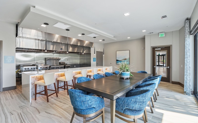 a clubroom kitchen with tables and chairs