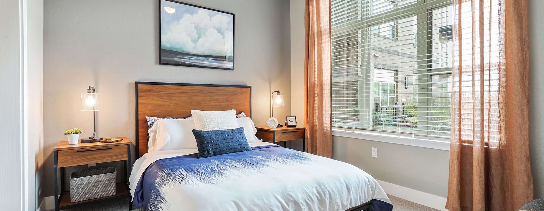 a bedroom with a bed and two nightstands
